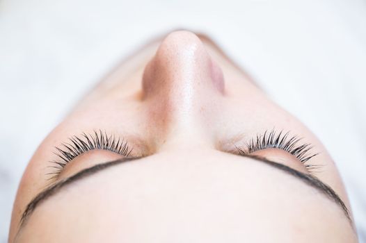 Close-up of a caucasian woman after eyelash lamination procedure