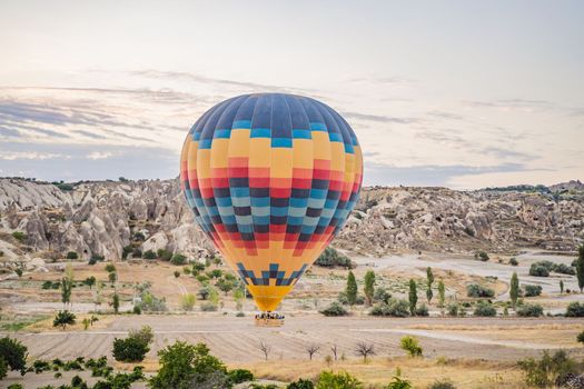 Colorful hot air balloon flying over Cappadocia, Turkey.