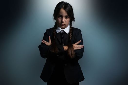 A girl with braids in a gothic style on a dark background