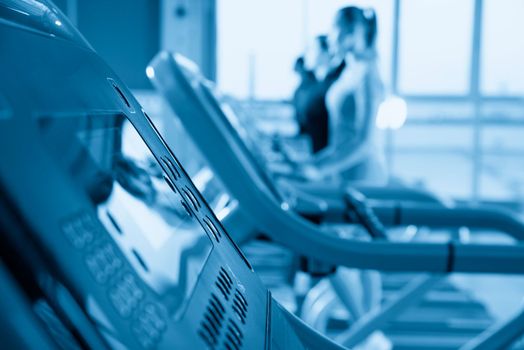 Young woman running on treadmill