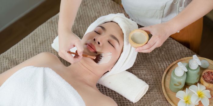 Young woman doing relaxing massage in spa salon. Female being massaged by a masseur. Spa and medicine concept.