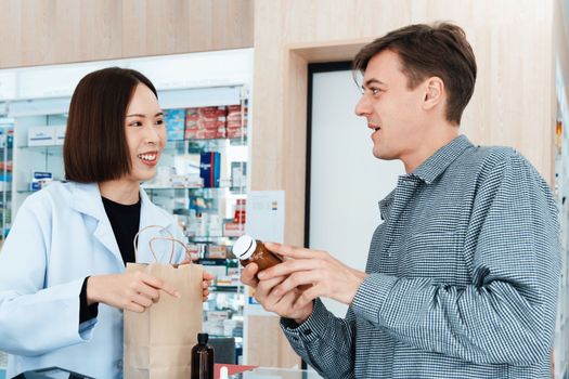 Professional pharmacist advise or explain property of qualified medical product to customer in pharmacy, druggist answer to client healthcare inquiry, medical service and consultation concept.