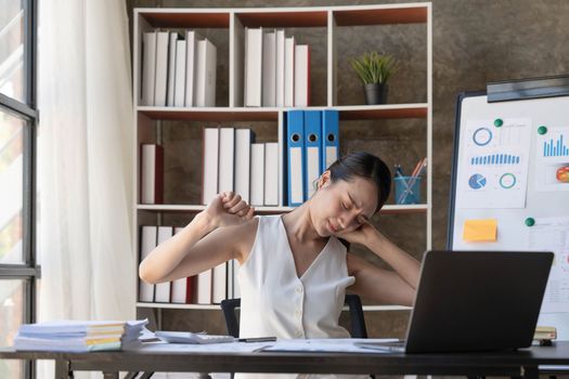 Young Business Asian women are stressed while working on laptop, Tired asian businesswoman with headache at office, feeling sick at work copy space in workplace an home office...