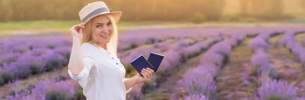 Portrait of a happy smiling woman holding passport in lavender field.