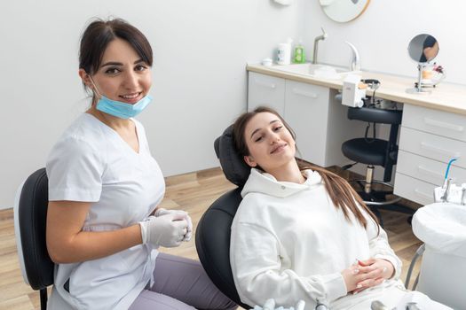 Orthodontist checking brackets on female teeth. Concept of stomatology, dentistry and orthodontic treatment of braces