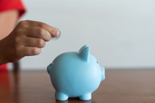 Pink piggy bank in the children's hands.