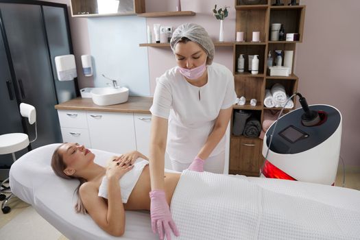 Endosphere therapy of female body by a cosmetologist in beauty salon