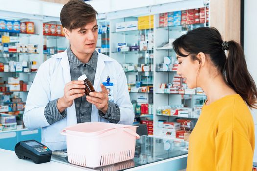 Professional pharmacist advise or explain property of qualified medical product to customer in pharmacy, druggist answer to client healthcare inquiry, medical service and consultation concept.