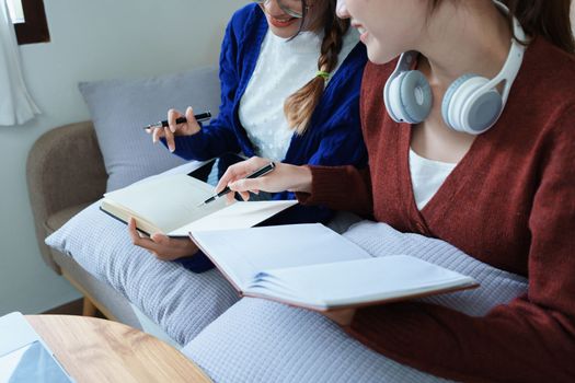 lgbtq, lgbt concept, homosexuality, portrait of two asian women posing happy together and loving each other while playing computer laptop with notebook for learning online.