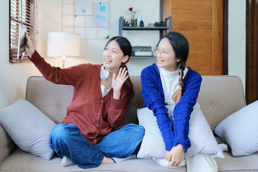 lgbtq, lgbt concept, homosexuality, portrait of two asian women enjoying together and showing love for each other while using tablet.
