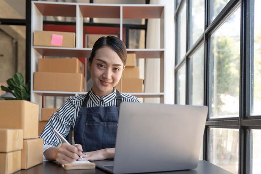 Starting small businesses SME owners female entrepreneurs check online orders to prepare to pack the boxes, sell to customers, sme business ideas online...