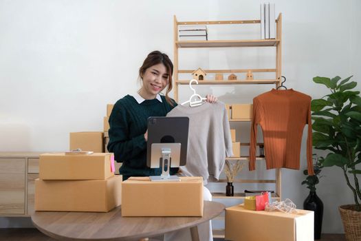 Online seller owner. Online shopping. Business Start up SME concept. Young startup entrepreneur small business owner working at home