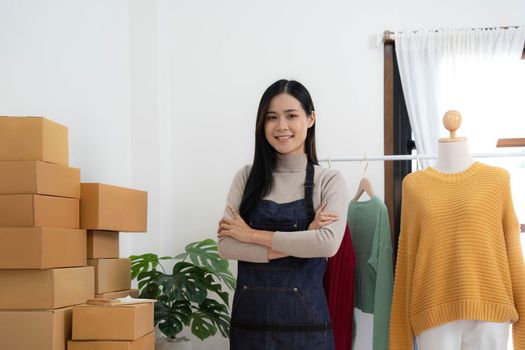 Startup small business entrepreneur SME, asian woman packing box. Portrait of young Asian small business owner in home office, online sell marketing delivery