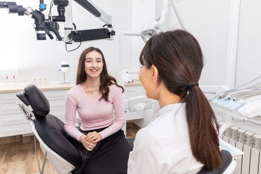 Dentist consulting young patient in a dental clinic