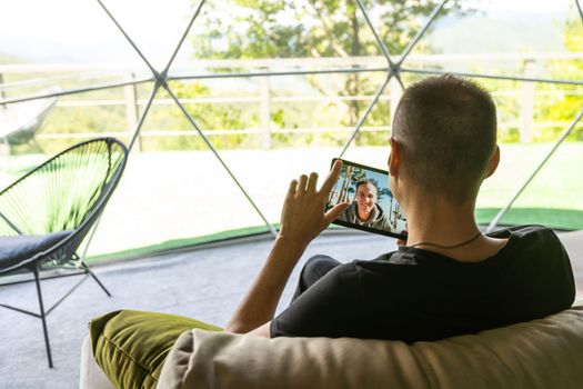 male hand holding tablet having video chat with colleagues. man watch online business webinar on digital tablet.