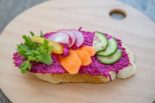 bread with beetroot spread and vegetables.