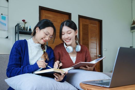 lgbtq, lgbt concept, homosexuality, portrait of two asian women posing happy together and loving each other while playing computer laptop with notebook for learning online.