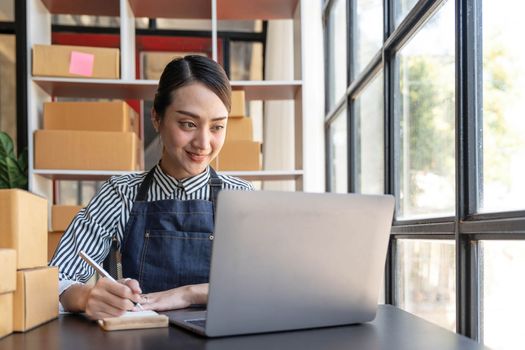 Starting small businesses SME owners female entrepreneurs check online orders to prepare to pack the boxes, sell to customers, sme business ideas online...