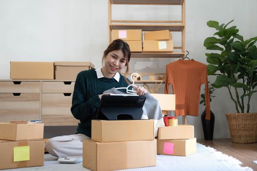 Online seller owner. Online shopping. Business Start up SME concept. Young startup entrepreneur small business owner working at home