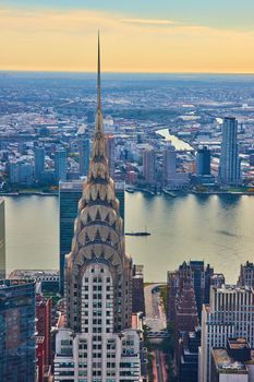 Image of Top of stunning New York City skyscraper vertical overlooking river and city
