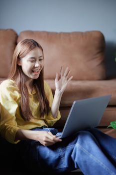 Portrait of a beautiful Asian teenage girl using a computer.