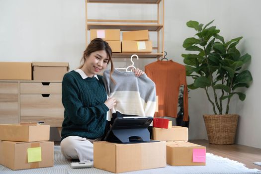 Online seller owner. Online shopping. Business Start up SME concept. Young startup entrepreneur small business owner working at home