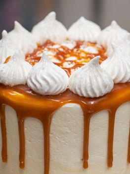professional baker decorating a chocolate and cream cake with salty caramel