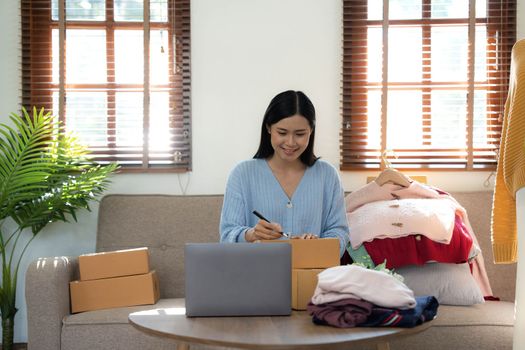 Startup small business entrepreneur SME, asian woman packing box. Portrait of young Asian small business owner in home office, online sell marketing delivery