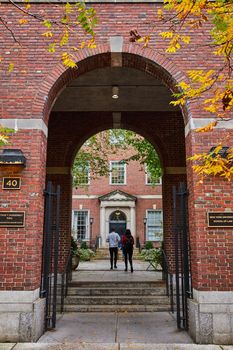 Image of Brick arch leading into law campus in New York City with students