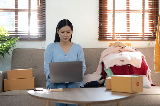 Startup small business entrepreneur SME, asian woman packing box. Portrait of young Asian small business owner in home office, online sell marketing delivery