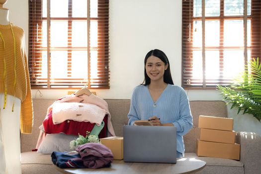 Startup small business entrepreneur SME, asian woman packing box. Portrait of young Asian small business owner in home office, online sell marketing delivery