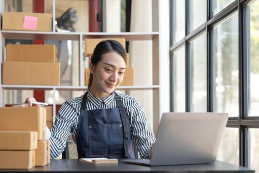 Starting small businesses SME owners female entrepreneurs check online orders to prepare to pack the boxes, sell to customers, sme business ideas online...