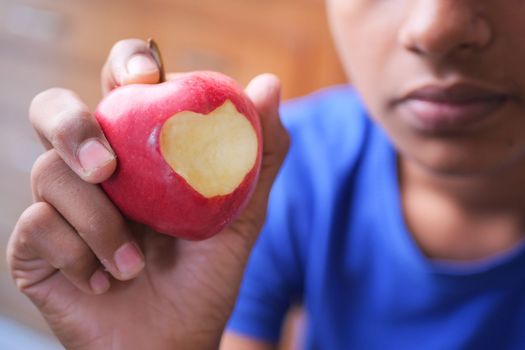 child boy eating apple close up .