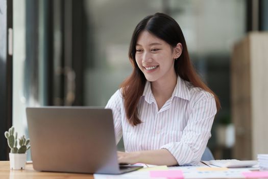 Asian Business woman working to analyze technical price graph and indicator. account or saving money or insurance concept.