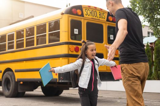 Parent taking child to school. Pupil of primary school go study with backpack outdoors. Father and son go hand in hand. Beginning of lessons. Back to school. First day of fall. Elementary student.