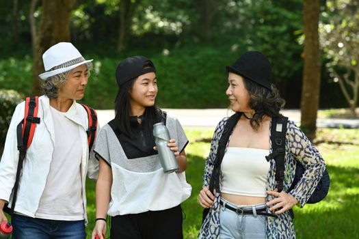 Active middle aged women tourist enjoy walking in public park on beautiful day. Retirement people lifestyle concept.