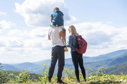 Happy family: mother, father, child daughter on nature.