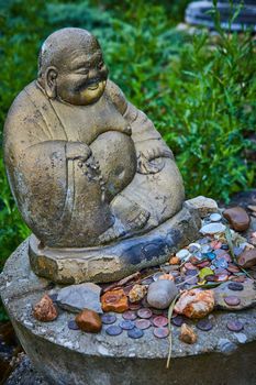 Image of Tibetan Mongolian Buddhist statue with collection of rocks