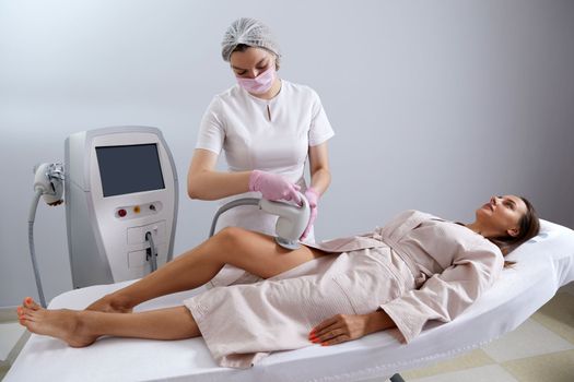 Woman Having Laser Treatment On Thigh. Ultrasound cavitation body contouring treatment. Anti cellulite treatment