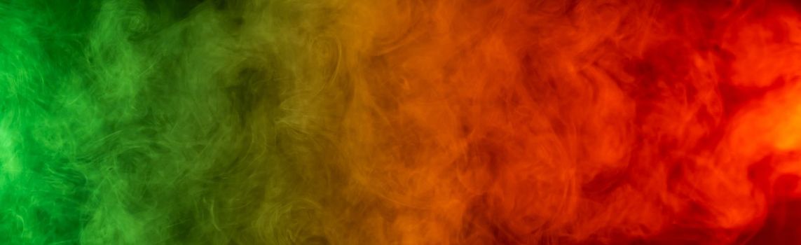 Red yellow green smoke on a black background