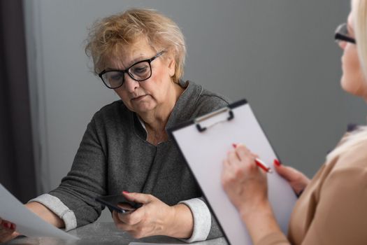 Parkinson and alzheimer female senior elderly patient with professional doctor consult in or counsel diagnosis health in hospital. Medical healthcare concept