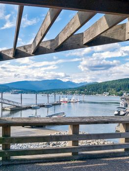 Pacific ocean bay overview from under the canopy. Motor boat pier in Port Moody inlet in Vancouver.
