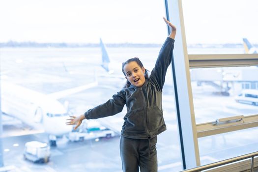 portrait of little girl at airport window.