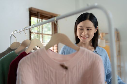 Young person using credit card and laptop computer. Online shopping, e-commerce concept.