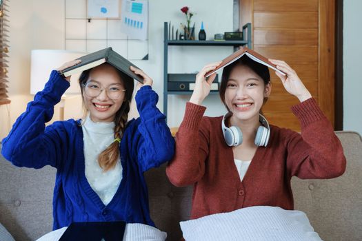 lgbtq, lgbt concept, homosexuality, portrait of two asian women posing happy together and loving each other while playing computer laptop with notebook for learning online.