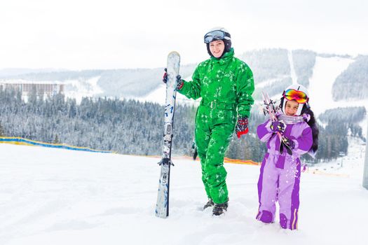 Ski, winter and fun - Family: mother and daughter enjoying winter vacations.