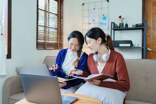 lgbtq, lgbt concept, homosexuality, portrait of two asian women posing happy together and loving each other while playing computer laptop with notebook for learning online.
