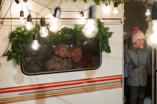 Father and two sons celebrate Christmas in a van