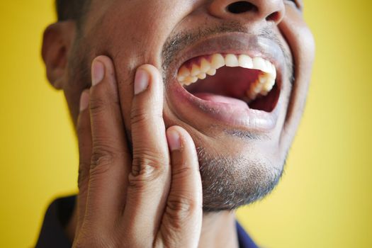young man with sensitive teeth close up .