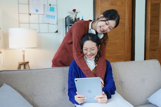 lgbtq, lgbt concept, homosexuality, portrait of two asian women enjoying together and showing love for each other while using tablet.